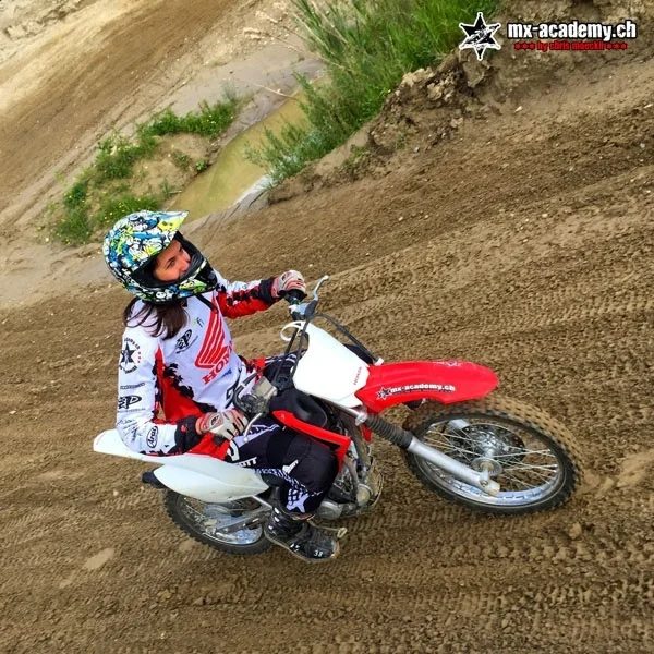 Women's motocross: female rider in a corner